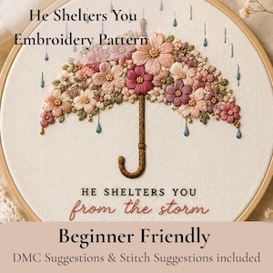 Könnte beinhalten: Stickmuster eines Regenschirms mit Blumendesign in Rosa-, Pfirsich- und Burgundertönen. Der Text "He Shelters You" und "from the storm" sind enthalten. Die Worte "Beginner Friendly" sind ebenfalls sichtbar.