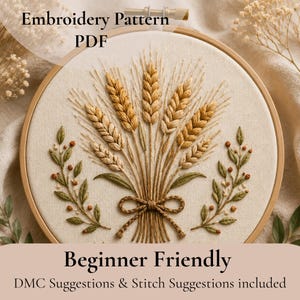 May include: An embroidery hoop with a wheat design. The wheat is stitched in shades of gold and brown, tied with a brown twine bow. Green leaves and red berries frame the wheat. Text reads "Embroidery Pattern PDF" and "Beginner Friendly".