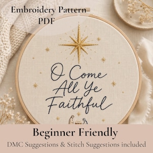 May include: A circular wooden embroidery hoop containing a cream-colored fabric with the hand-stitched dark blue text O Come All Ye Faithful, a large gold star at the top, smaller gold stars scattered around, and a small nativity scene at the bottom.