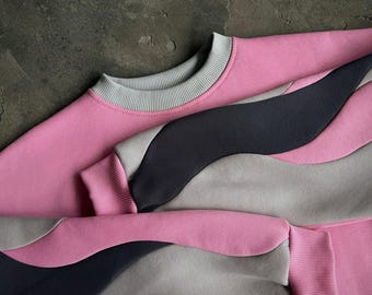 Übergroßes zweifarbiges Sweatshirt in Pink und Anthrazit mit gewellten Ärmeln