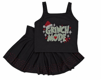 May include: A black tank top and matching skirt set. The tank top features a rhinestone graphic that reads GRINCH MODE in green, with a red Santa hat, a red heart, and a red bow. The skirt has a row of small red rhinestones along the hem.
