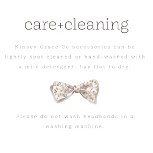 May include: Care and cleaning instructions for Kinsey Grace Co accessories. The text states that accessories can be lightly spot cleaned or hand-washed with a mild detergent. Lay flat to dry. It also states that headbands should not be washed in a washing machine. The image includes a floral bow tie.