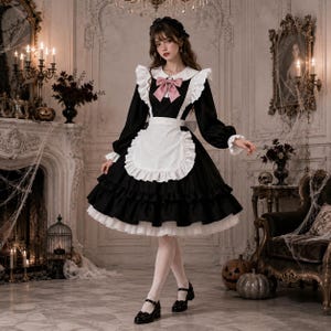 May include: A black long-sleeved dress with a white collar, a white ruffled apron, and a pink bow at the neckline. The dress features a full, layered skirt with white petticoat trim, long sleeves with ruffled cuffs, and a matching black headpiece.