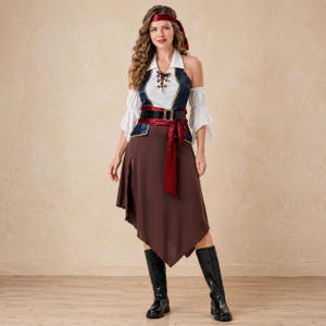 May include: A pirate-themed costume featuring a white blouse with flared sleeves, a blue and white vest with a lace-up front, a brown asymmetrical skirt, a black belt with a gold buckle, a red waist sash, and a matching red headscarf with black boots.