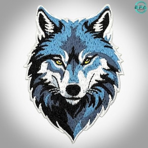 May include: An embroidered patch featuring the head of a wolf in shades of blue, black, and white. The wolf has piercing yellow eyes, pointed ears, and detailed fur texture. The design is outlined with a white border, creating a sharp contrast.