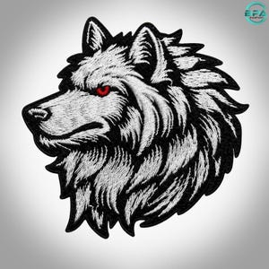 Peut inclure: Un écusson brodé représentant le profil d'une tête de loup. Le motif utilise du fil blanc pour la texture du pelage sur un fond noir, avec un œil rouge vif comme point focal. Le loup est orienté vers la gauche avec des coutures précises.