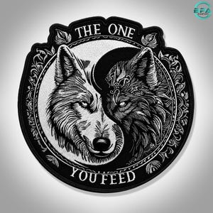 May include: A circular black and white embroidered patch featuring a yin-yang design composed of two wolf heads. The text THE ONE YOU FEED is arched around the central circular border, which is decorated with intricate leaf and vine patterns.