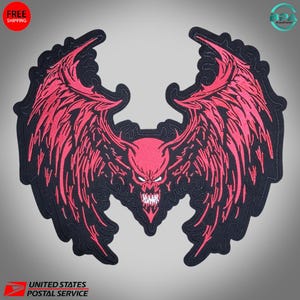 May include: A red devil patch with large wings and a menacing expression. The patch has a black border and is likely designed to be ironed or sewn onto clothing or accessories. The design features sharp details and a bold aesthetic.