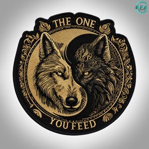 May include: A circular embroidered patch featuring two wolf heads in a yin-yang arrangement. The design uses gold and black thread to depict the wolves within an ornate border. The text THE ONE is arched above and YOU FEED is arched below.