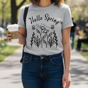 Maglietta floreale "Ciao primavera", t-shirt con grafica ispirata alla natura e ai fiori.
