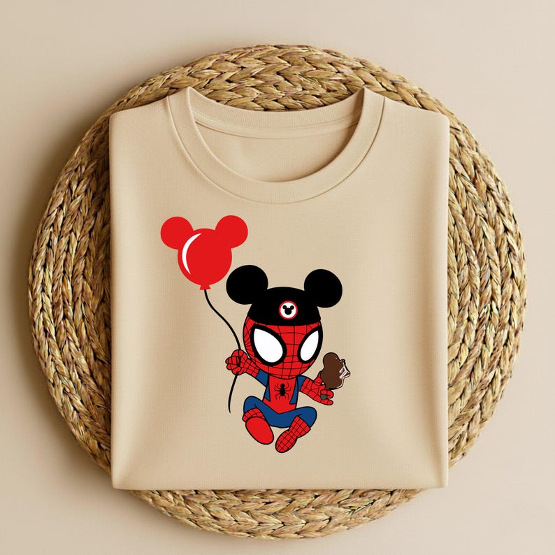 May include: A beige t-shirt featuring a cartoon character that is a hybrid of Spider-Man and Mickey Mouse. The character is holding a red balloon and a chocolate ice cream cone. The design is in red, black, and blue.