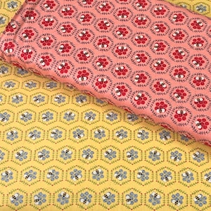 May include: Two fabric swatches with a repeating pattern of bees and honeycombs. The top swatch is pink with red bees and the bottom swatch is yellow with blue bees.