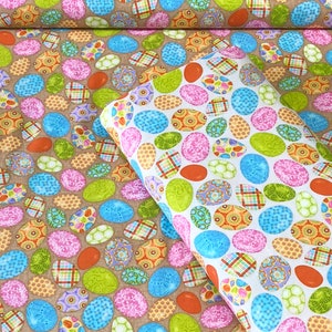 May include: A brown fabric with a repeating pattern of colorful Easter eggs. The eggs are decorated with different designs, including plaid, floral, and swirls. The fabric is perfect for crafting projects, such as quilts, pillows, and table runners.