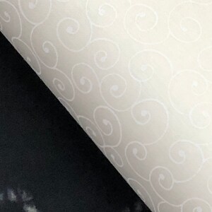 May include: A white fabric with a repeating pattern of white swirls on a white background.