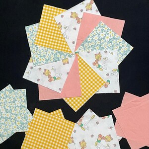 May include: A collection of fabric squares in various patterns, including gingham, floral, and a white background with a repeated image of a girl and a goose. The squares are in shades of yellow, pink, and blue.