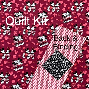 May include: A quilt kit featuring a burgundy fabric with a repeating pattern of Mickey and Minnie Mouse. Includes a red polka dot fabric, a black and white floral fabric, and the text "Quilt Kit" and "Back & Binding".