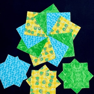 May include: A collection of 10 fabric squares featuring a repeating pattern of green turtles on a yellow background. There are also two solid green and two solid blue squares.