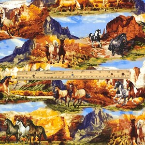 May include: A colourful fabric with a repeating pattern of horses and mountains. The horses are brown, black, white, and tan. The mountains are blue, purple, and brown. The fabric has a blue sky background with white clouds.