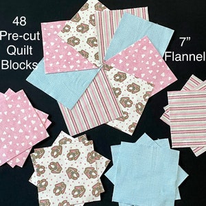 May include: 48 pre-cut 7" flannel quilt blocks in pink, blue, and white with bunny and heart patterns.