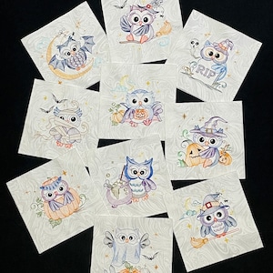May include: Ten different Halloween-themed embroidery designs featuring owls in various costumes and poses. The designs are on white fabric with a swirled pattern. The owls are wearing costumes such as a witch hat, a mummy wrap, and a ghost costume. The designs are perfect for adding a touch of Halloween fun to your home decor.