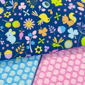 May include: Three fabric swatches with different patterns. The top swatch is a dark blue fabric with a repeating pattern of small animals, flowers, and leaves. The middle swatch is a light blue fabric with a repeating pattern of small white animals. The bottom swatch is a pink fabric with a repeating pattern of small white animals.