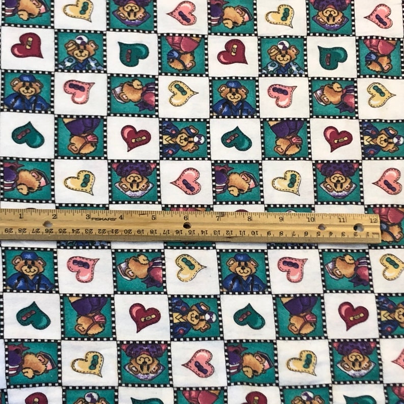May include: White fabric with a checkered pattern of green and white squares. Each square features a cartoon bear wearing a sailor hat and holding a heart. The hearts are in various colors, including red, pink, yellow, and green.