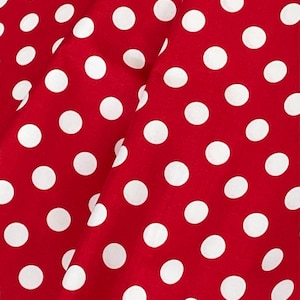 May include: Red fabric with a white polka dot pattern.