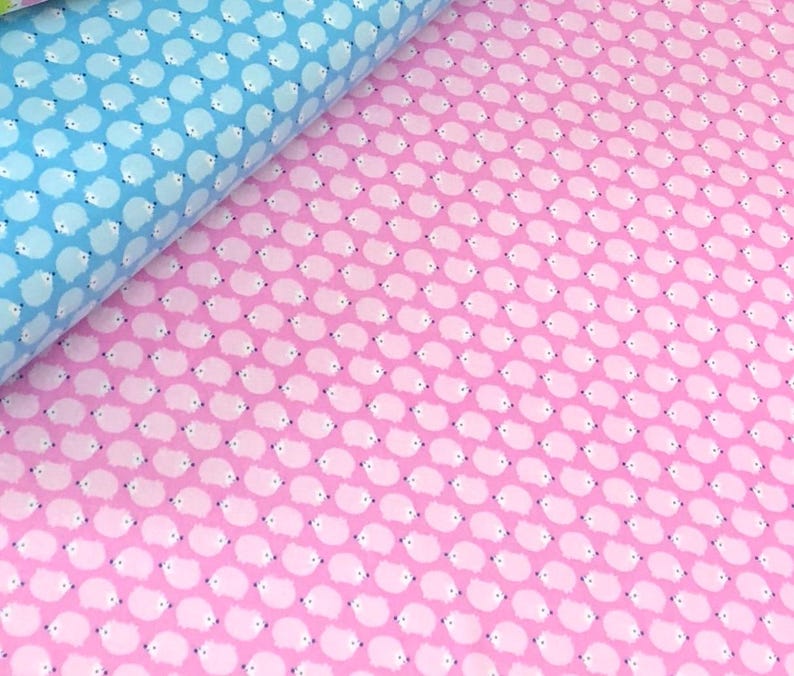 May include: Pink fabric with a repeating pattern of white hedgehogs. The hedgehogs are facing to the right.