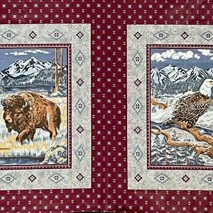 May include: A red fabric with two squares featuring nature scenes. The left square shows a brown bison standing in a snowy mountain landscape. The right square shows a white-headed eagle perched on a branch in a snowy mountain landscape.