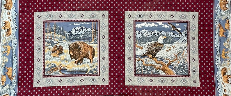 May include: A red fabric with two squares featuring nature scenes. The left square shows a brown bison standing in a snowy mountain landscape. The right square shows a white-headed eagle perched on a branch in a snowy mountain landscape.