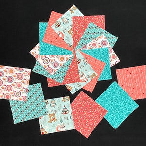May include: A collection of 12 fabric squares with a variety of patterns, including teal and coral colors. The patterns include geometric shapes, animals, and Native American inspired designs.