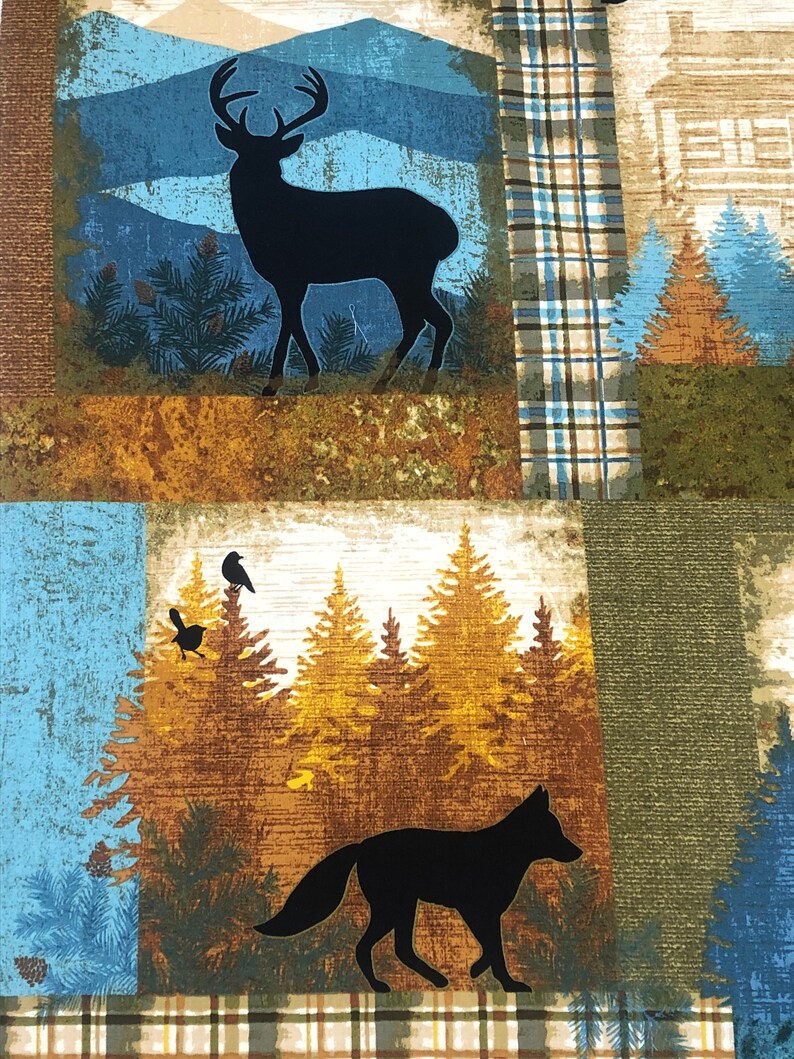 May include: A fabric panel featuring a woodland scene with a black silhouette of a deer, fox, and birds. The design includes pine trees, mountains, and plaid patterns in shades of blue, brown, and green.
