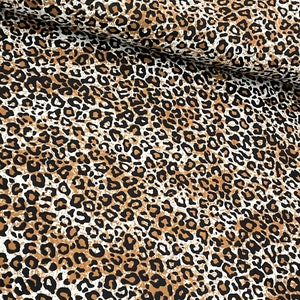 May include: Brown, black, and white leopard print fabric with a subtle distressed look.
