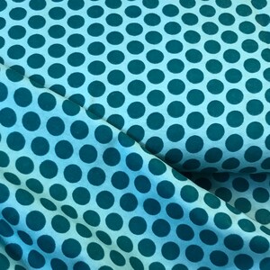 May include: Teal blue fabric with a white polka dot pattern.