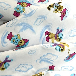 Teddy Bear rain shower, blue clouds, pink umbrella, rain drops, flannel fabric, baby blanket, yellow rain coat, rain boots, pink polka dots