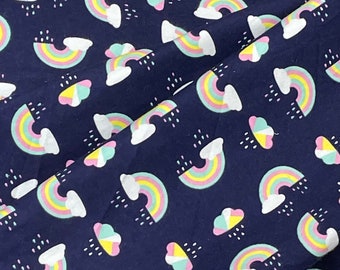 May include: Navy blue fabric with a repeating pattern of colorful rainbows and clouds with raindrops.