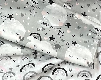 May include: Gray and white fabric with a repeating pattern of rainbows, clouds with faces, stars, and hearts. The text "Sweet dreams" and "Hello sunshine" is printed on the fabric.