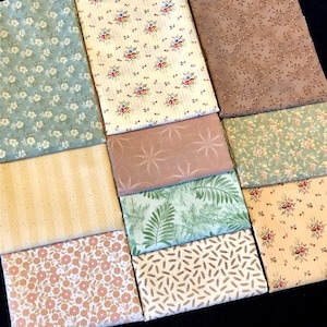 May include: A collection of 10 fabric squares in various floral and geometric patterns. The fabrics are in shades of green, brown, beige, and pink.