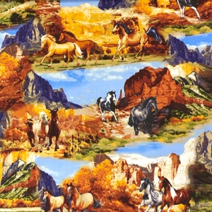 May include: A colourful fabric featuring a repeating pattern of horses running through a desert landscape with rocky mountains and canyons. The horses are brown, white, and black with flowing manes and tails. The background is a mix of brown, orange, and yellow hues.