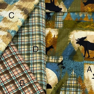 May include: Four fabric swatches labeled A, B, C, and D. Swatch A features a forest scene with moose and birds. Swatch B is a brown and teal plaid. Swatch C has a textured tan and teal pattern. Swatch D is a green, blue, and yellow plaid.