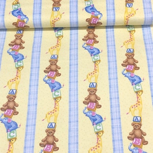 May include: Yellow fabric with a repeating pattern of blue stripes, elephants, giraffes, and teddy bears. The pattern features the letters A, B, and C on each block.