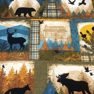 May include: Fabric with a patchwork design featuring woodland scenes. Each square showcases silhouettes of animals like a bear, deer, fox, and moose, set against a backdrop of trees, mountains, and a cabin. The color palette includes shades of blue, brown, and green.