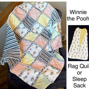 May include: A Winnie the Pooh rag quilt with a patchwork design in pastel colors, including yellow, pink, and white, featuring Winnie the Pooh characters. A matching sleep sack is also shown.