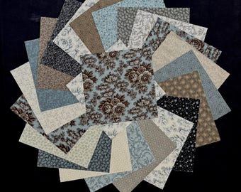 May include: A collection of square fabric swatches arranged in a circular fan pattern. The fabric pieces feature various patterns including floral prints, damask, and small geometric designs in shades of light blue, brown, cream, and black.