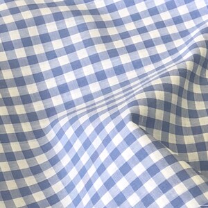 May include: Blue and white gingham fabric with a subtle texture. The fabric is folded and has a slight wrinkle.