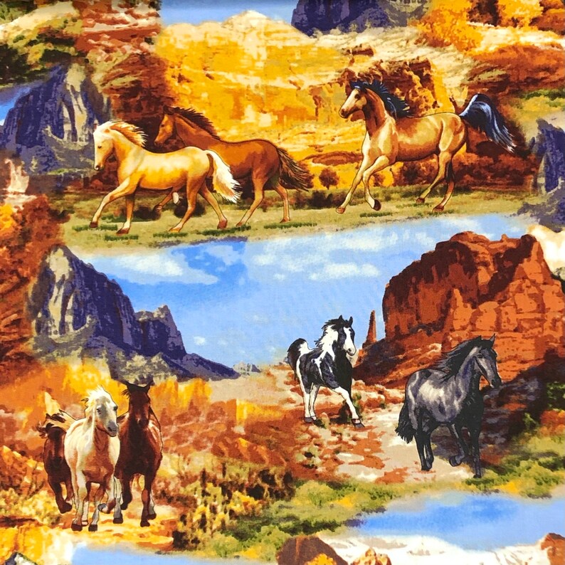 May include: A colourful fabric featuring a repeating pattern of horses running through a desert landscape. The horses are brown, white and black with white markings. The background is a mix of brown, yellow and blue.