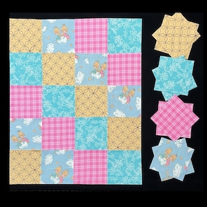 May include: A patchwork quilt with a checkerboard pattern of yellow, pink, and blue squares. Some squares feature a floral design, others a plaid pattern, and some have an illustration of cherubs. Several star-shaped fabric pieces are next to the quilt.