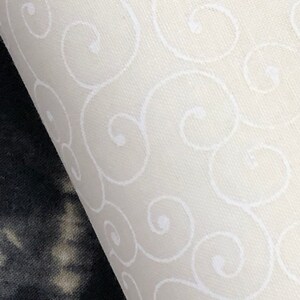 May include: White fabric with a repeating pattern of white swirls.