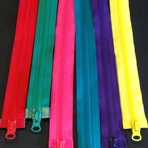 May include: Six different colored zipper tapes with metal zipper pulls. The colors are red, green, pink, blue, purple, and yellow.