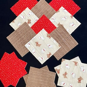 May include: A set of ten fabric squares in three different patterns. There are three red squares with white stars, three brown squares with white stripes, and four cream squares with a white dog and brown spots pattern.